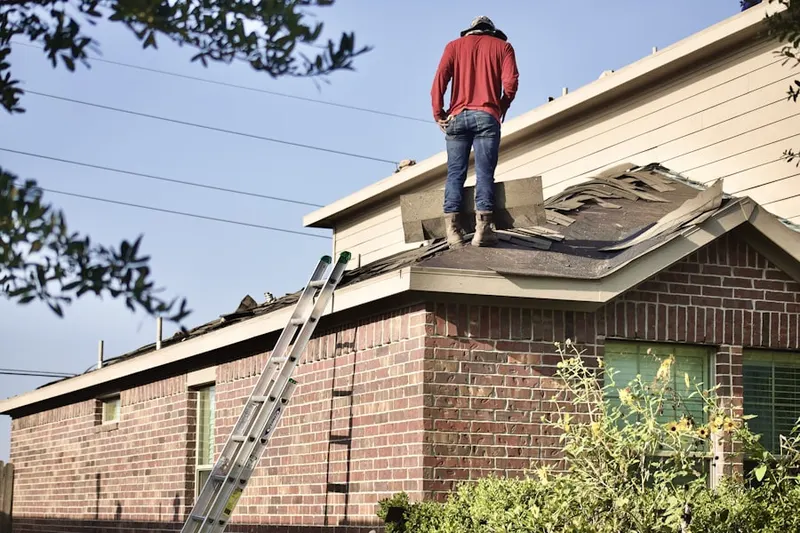 Professional roofer working on a residential roof in East Side Commercial Area